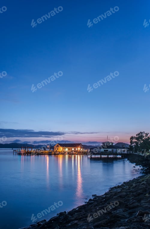 Preview: 53830,Illuminated buildings on water at dawn