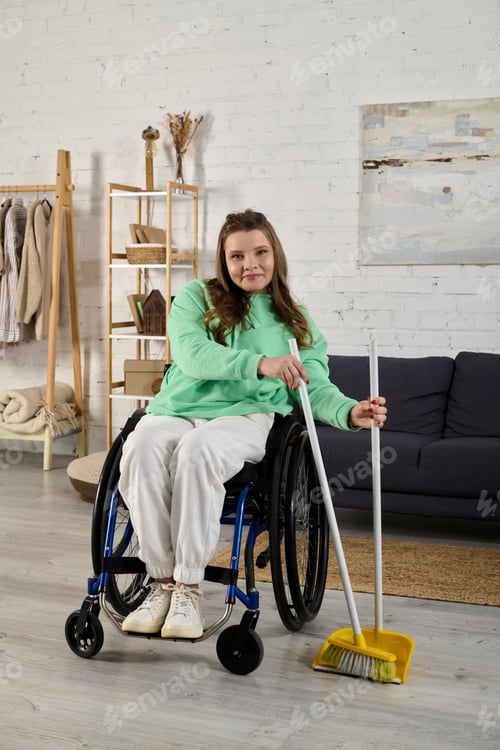Preview: A young woman in a wheelchair sweeps her living room