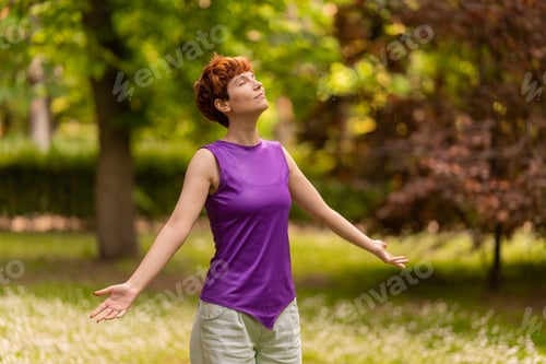 Preview: Androgynous woman enjoying fresh air in park