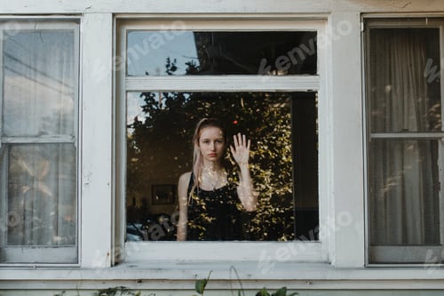 Preview: Girl looking out the window of her LA home during the covid-19 pandemic