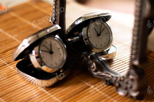 Preview: Pocket folding watch in the mirror. Time concept