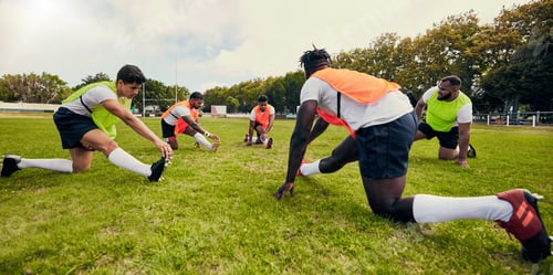 Preview: Sports, training and men outdoor for rugby on grass field with diversity team stretching as warm up