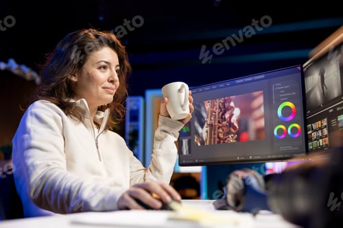 Preview: Specialist starting his day with cup of coffee in post production studio