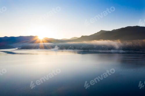 Preview: Lovely autumnal landscape with fog over the lake.