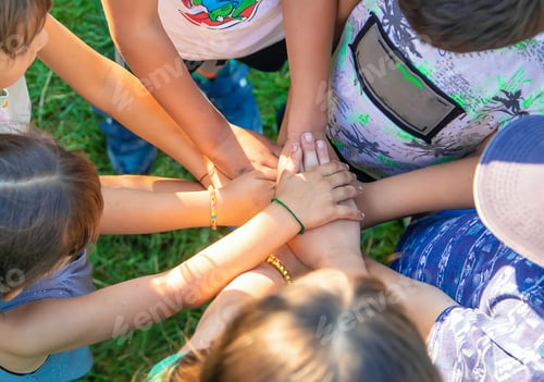 Preview: The children put their hands together. Selective focus.