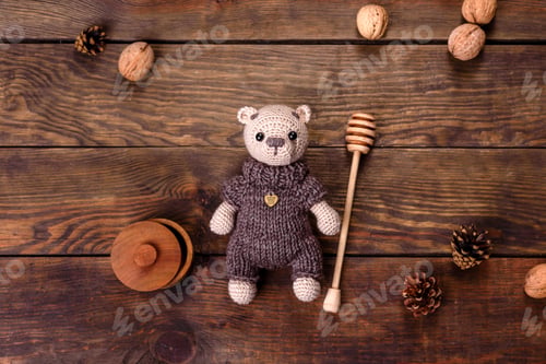 Preview: Toy bear tied from woolen threads on a dark background