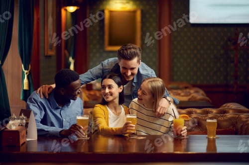 Preview: Four friends drinks alcohol at the counter in bar