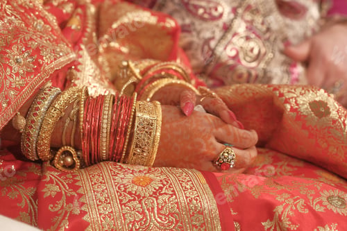 Preview: In a traditional Indian wedding, adorned hands showcase ornate bangles and beautiful rings