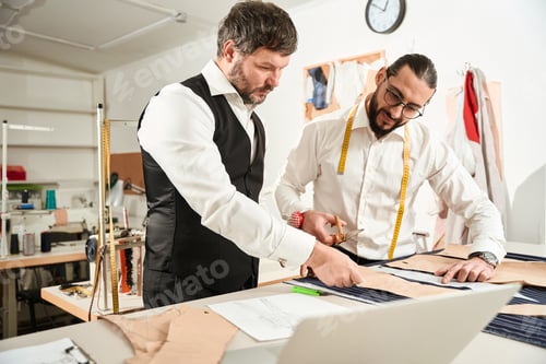 Preview: Two Men Designing Clothing in Fashion Studio