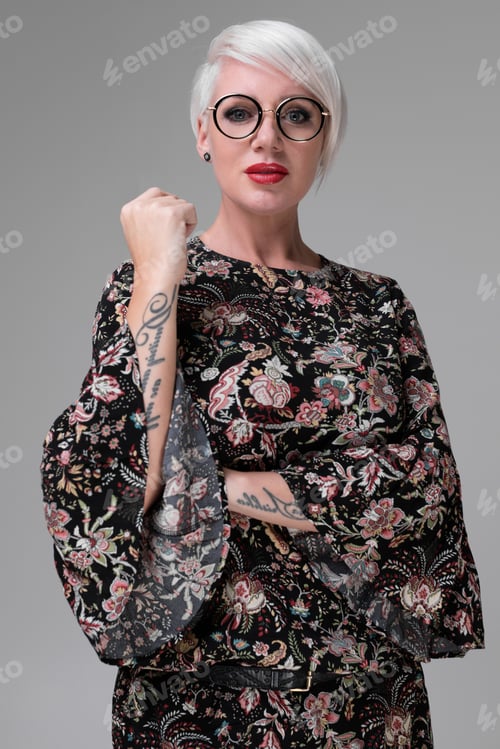Preview: Portrait of young blonde girl with glasses isolated on light background