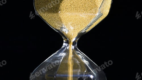 Preview: Close-up of golden hourglass. Stock footage. Stylish hexagon hourglass with falling gold specks on