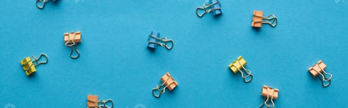 Preview: panoramic shot of colorful paper clips isolated on blue