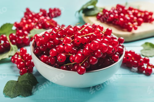 Preview: Delicious red currants on light blue wooden table