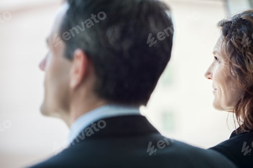 Preview: Caucasian business woman looking out the window of a conference centree lobby.