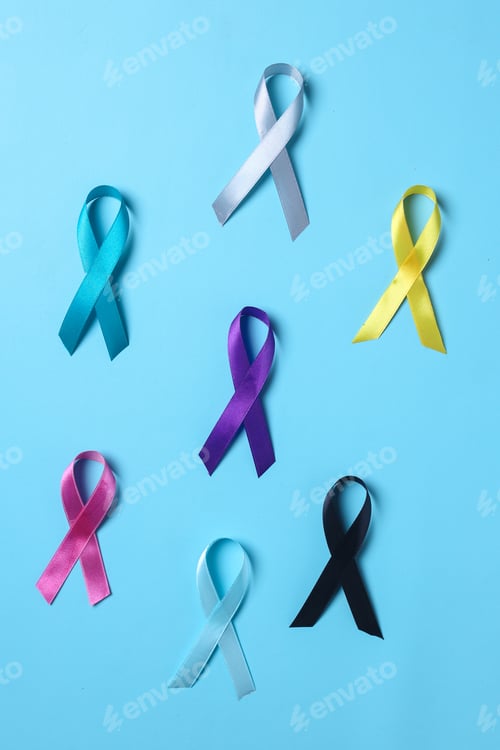 Preview: Multi-color ribbons on blue background. Cancer awareness, World cancer day.