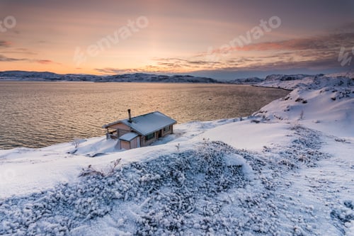 Preview: Cottage on the shore of the Arctic Ocean at sunset in winter