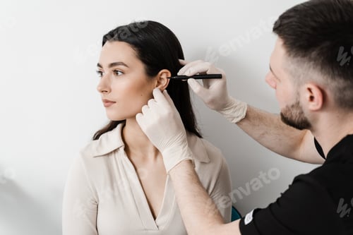 Preview: Otoplasty markings surgeon marks girl?s ear for pre-op cosmetic pinna reshaping surgery
