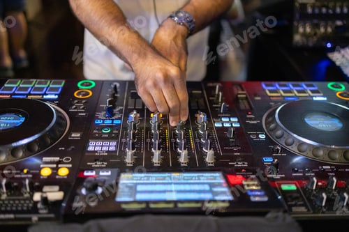 Preview: DJ's Hands Adjusting Music Mixer at Event