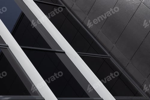 Preview: close-up of black glass wall and black wall covered with rugged tiles