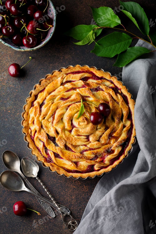 Preview: Homemade open cherry pie with lattice on a dark concrete background. Selective focus. Top view