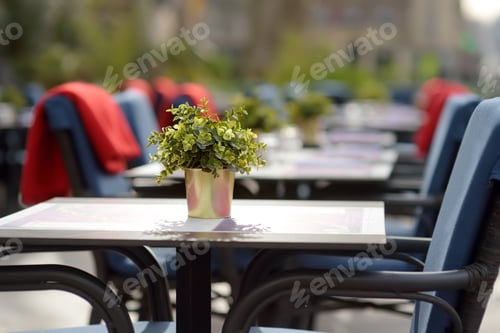 Preview: An empty stylish street cafe in a European city in autumn or winter. Cozy outdoor restaurant.