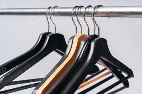 Preview: Wooden Clothes Hangers on Metal Closet Rod