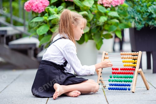 Vista previa: Happy little schoolgirl with a chalkboard outdoor
