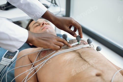 Preview: Cropped image of female african american doctor or nurse sticking holter and vacuum electrodes on
