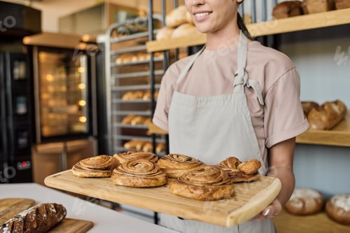 Preview: Holding wooden tray with fresh appetizing pastry