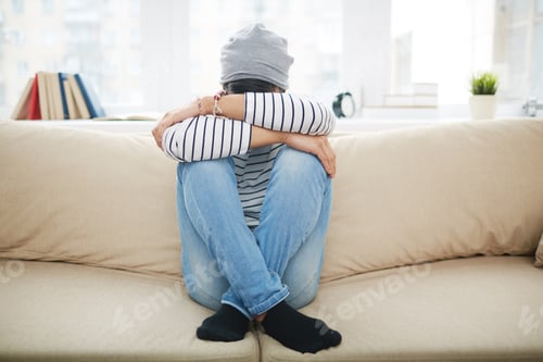 Teen Sitting Sad on Couch with Crossed Arms