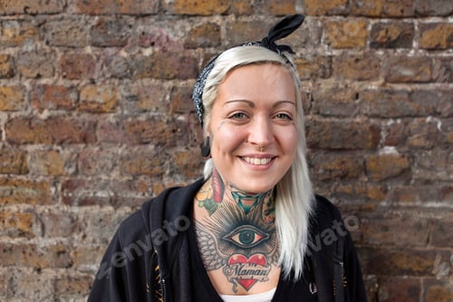 Preview: Portrait of young woman with nose ring stud and tattoo