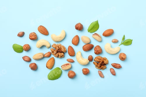 Preview: Different nuts on blue background, top view. Vitamin food