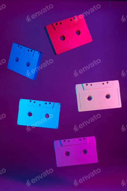 Preview: Colored audio cassettes hanging in the air against purple background