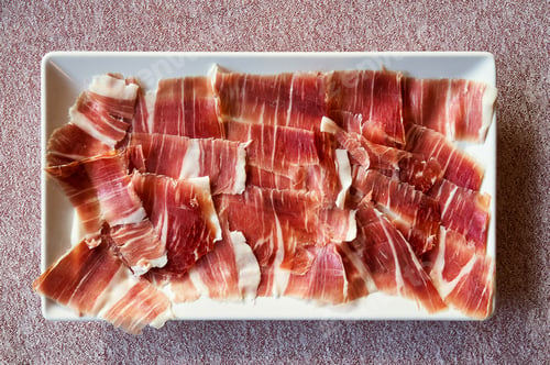 Preview: appetizer plate of freshly sliced iberian acorn-fed acorn-fed ham