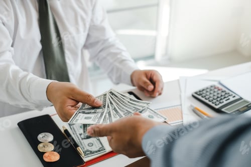 Preview: Businessman gives money to his employee or his partner.