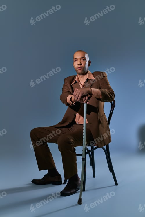 Preview: diversity and inclusion, african american man with myasthenia gravis syndrome sitting on chair