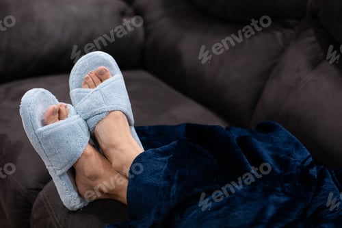 Preview: Light blue slippers against a dark gray couch