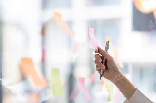 Preview: Young Asian woman Creative team use post it notes to share idea sticky note on glass wall. Asian