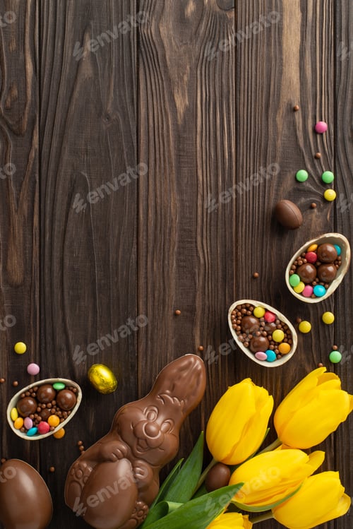 Preview: Festive Easter candy display: Top view vertical photo of chocolate eggs cracked open