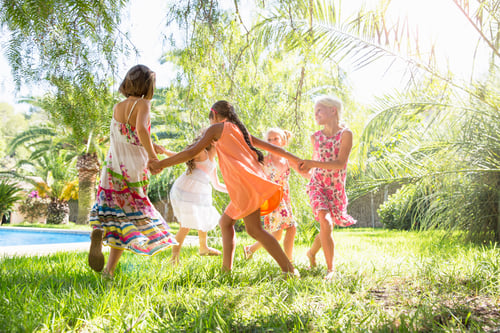 Preview: Five girls playing ring a ring a roses in garden