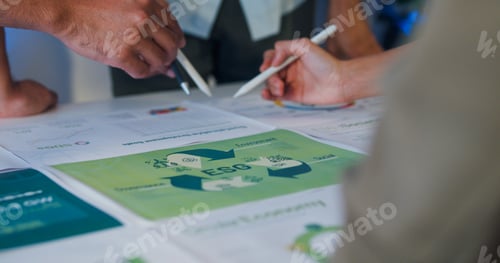 Preview: Closeup group Asia businesspeople talk ESG strategies risk management workshop night.