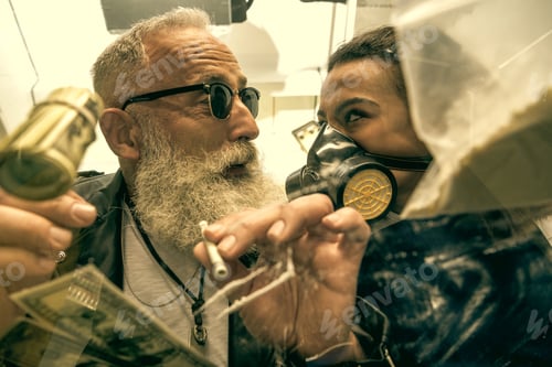 Preview: grey hair man with beard taking drugs with woman in personal protective equipment, drugs concept