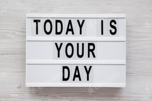 Preview: Modern board with text 'Today is your day' on a white wooden background, top view.