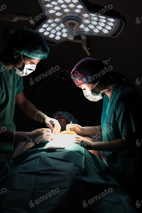 Preview: Doctors during operation in hospital operating room with patient