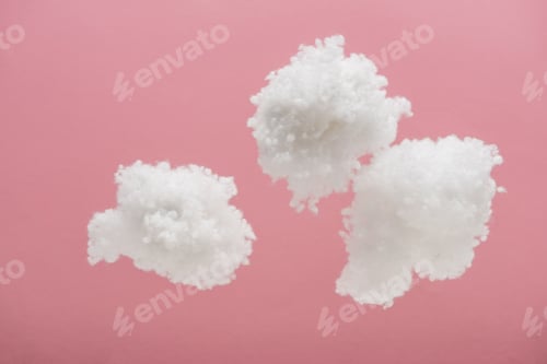 Preview: white fluffy clouds made of cotton wool isolated on pink