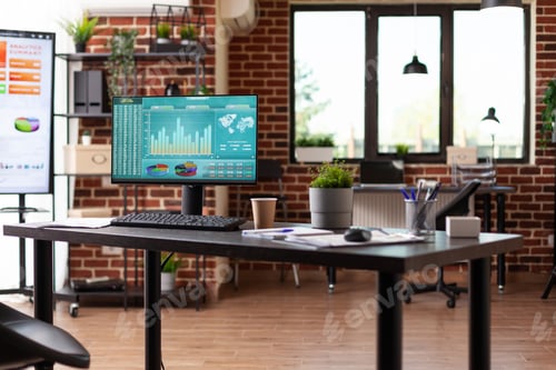 Preview: Computer with stock market statistics in empty business office