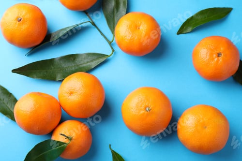 Preview: Fresh ripe tangerines on light blue background, flat lay