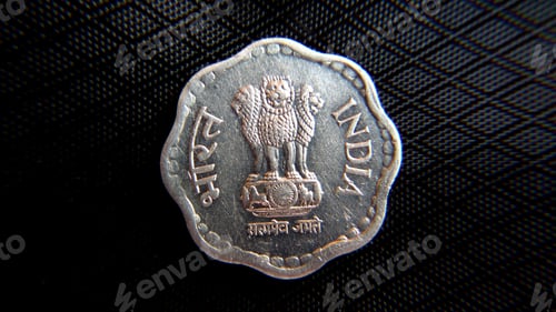 Preview: Closeup shot of a coin representing Indian currency on the dark background