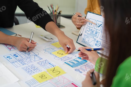 Preview: developer team brainstorming on their project with laptop, smartphone and digital tablet.