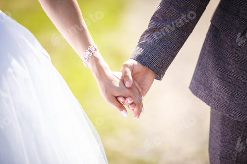 Preview: romantic couple holding hands. Lovers or newlywed married young couple in romance. wedding theme